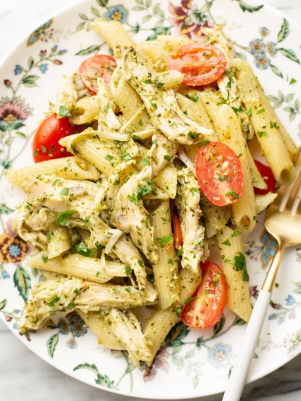 a plate with chicken pesto pasta salad and a fork