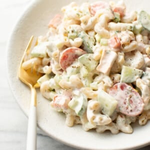 a bowl of creamy tuna pasta salad with a fork