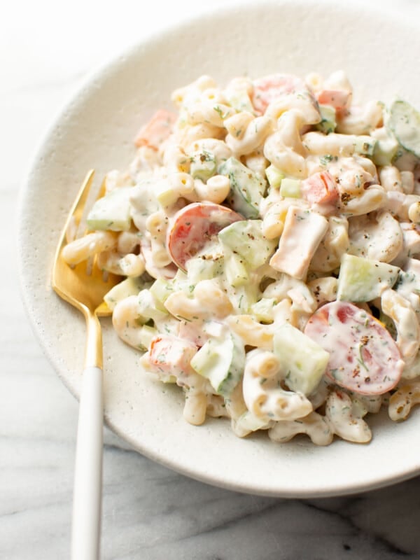 a bowl of creamy tuna pasta salad with a fork