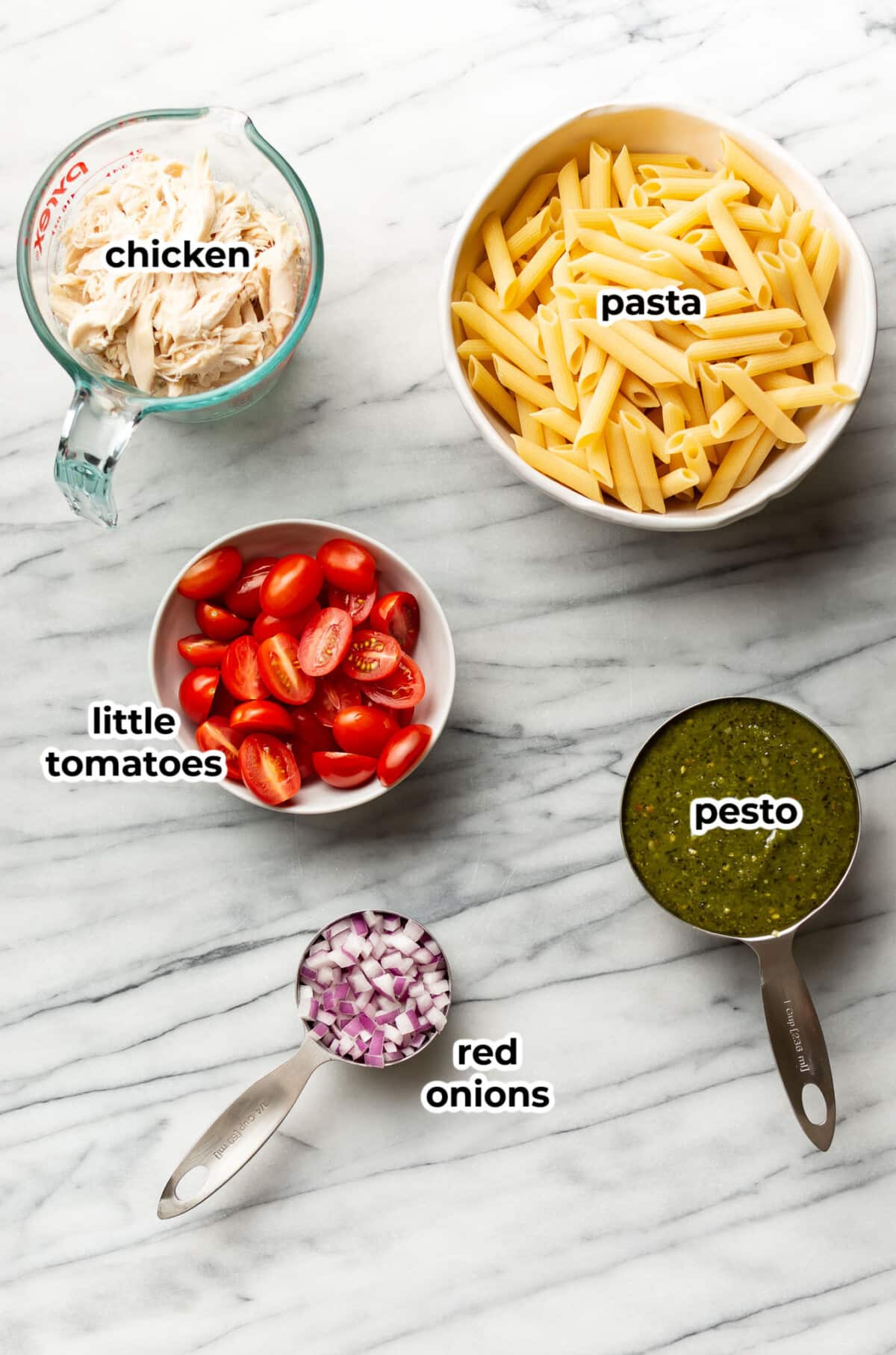 ingredients for chicken pesto pasta salad in prep bowls