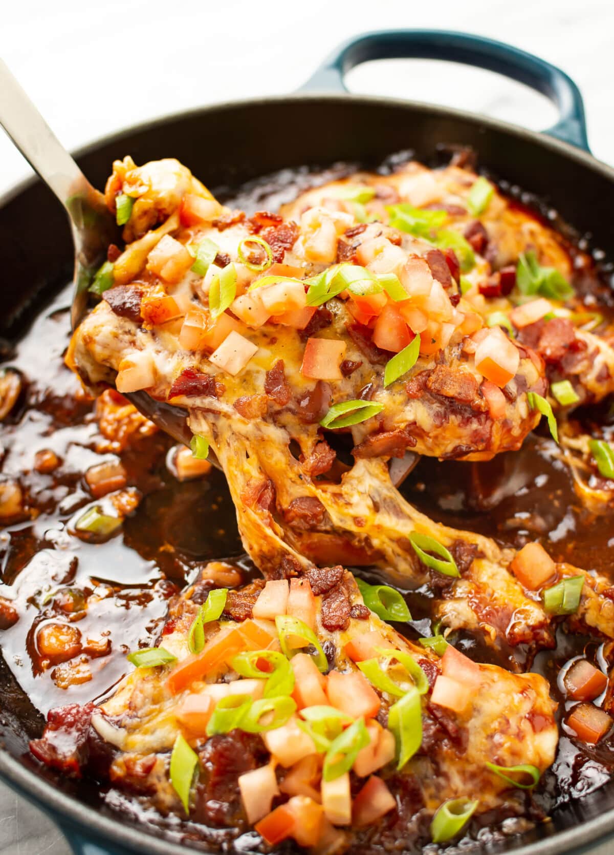 a skillet with monterey chicken and a serving spatula