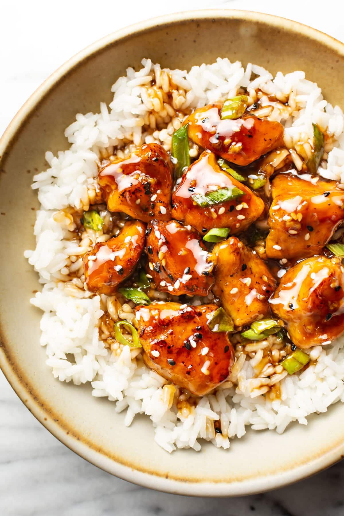 a bowl of teriyaki chicken over jasmine rice