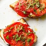 two summer tomato sandwiches on a plate