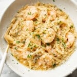 a bowl of shrimp scampi orzo with a fork