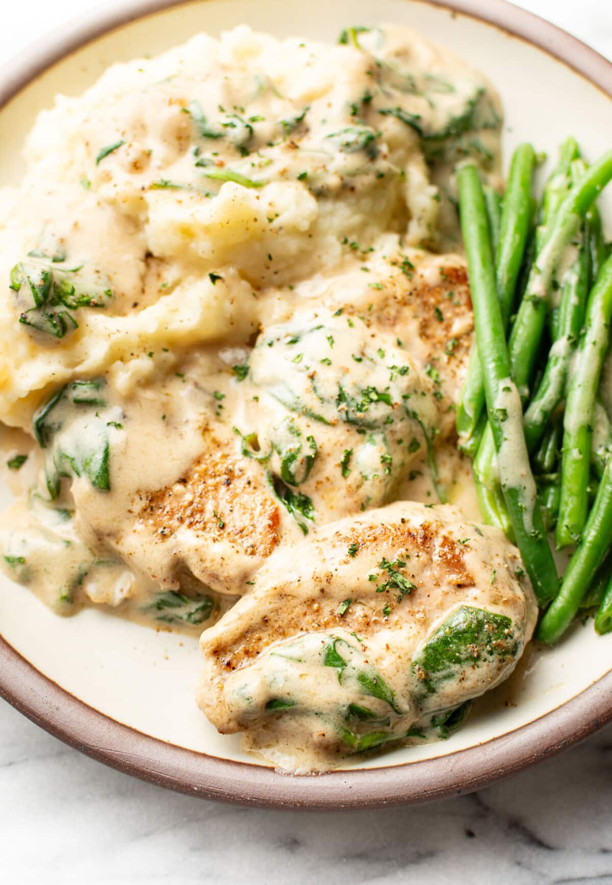 a plate with cream of mushroom soup pork tenderloin, green beans, and mashed potatoes