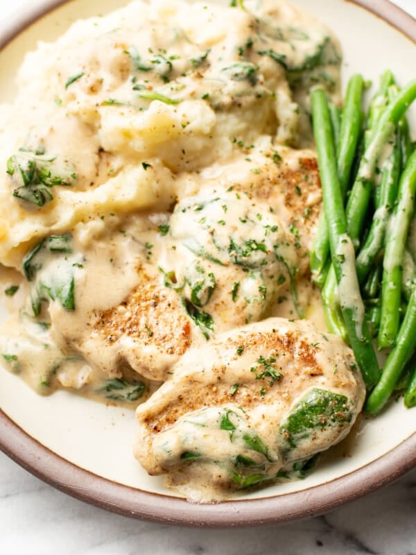 a plate with cream of mushroom soup pork tenderloin, green beans, and mashed potatoes