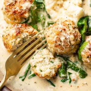 a plate with chicken florentine meatballs and a fork