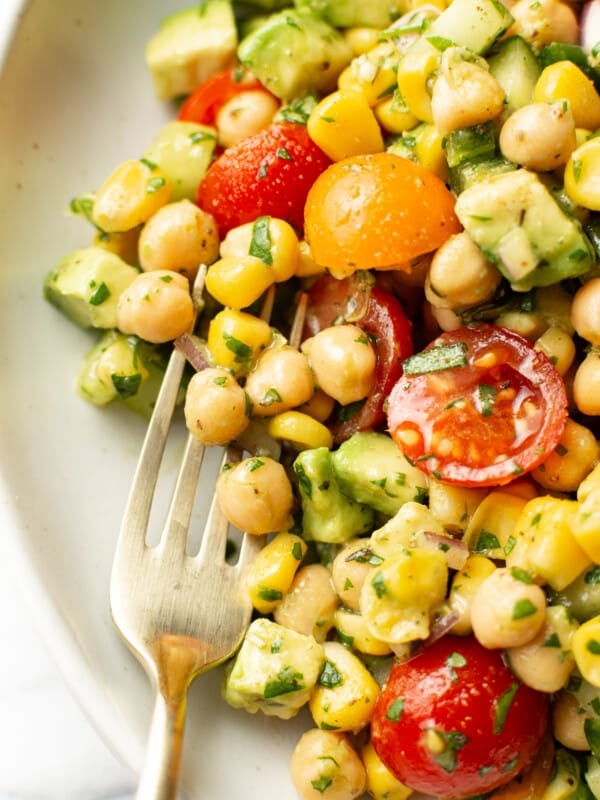 a bowl of chickpea salad with a fork
