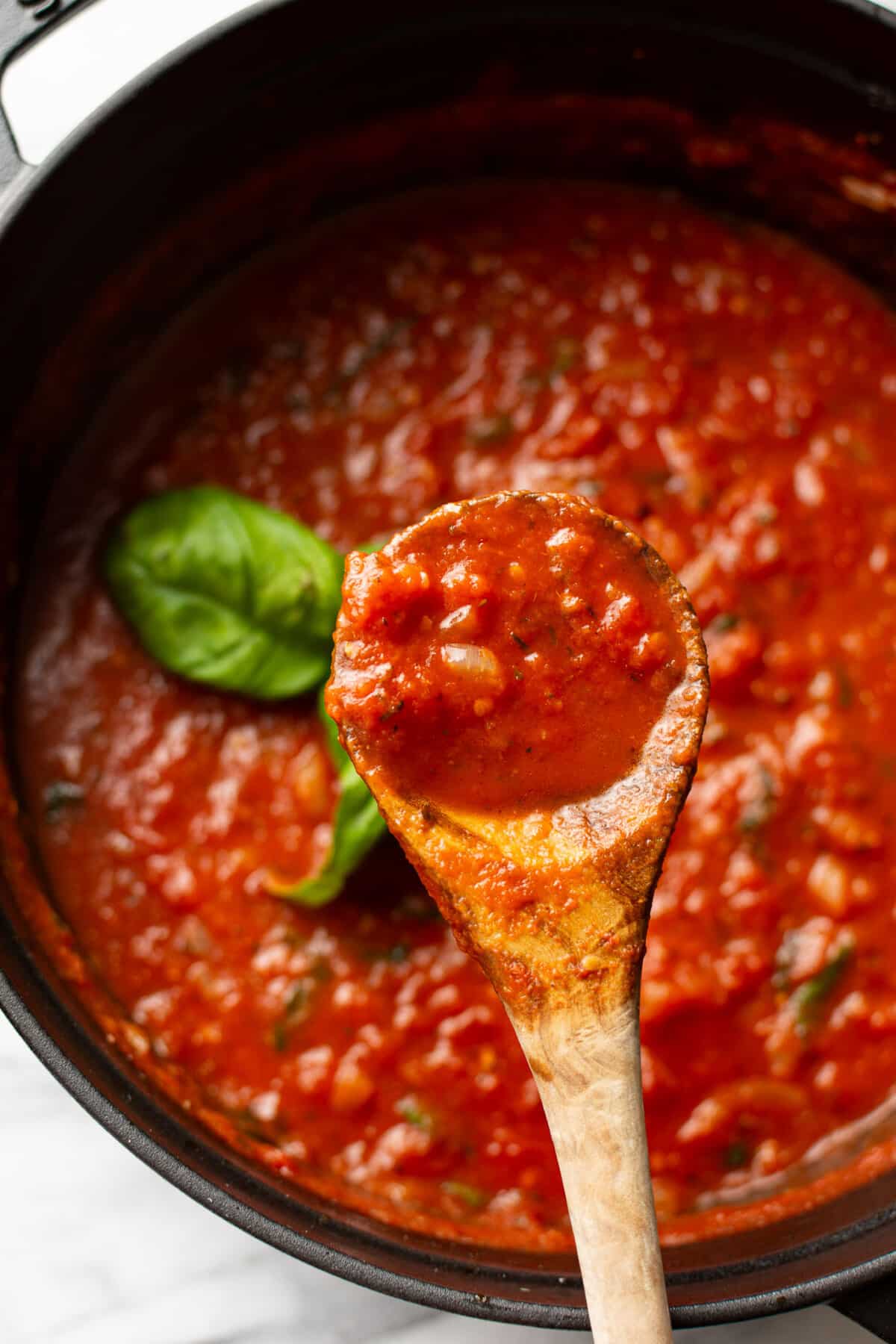 tomato sauce with a wooden spoon