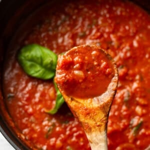 tomato sauce with a wooden spoon
