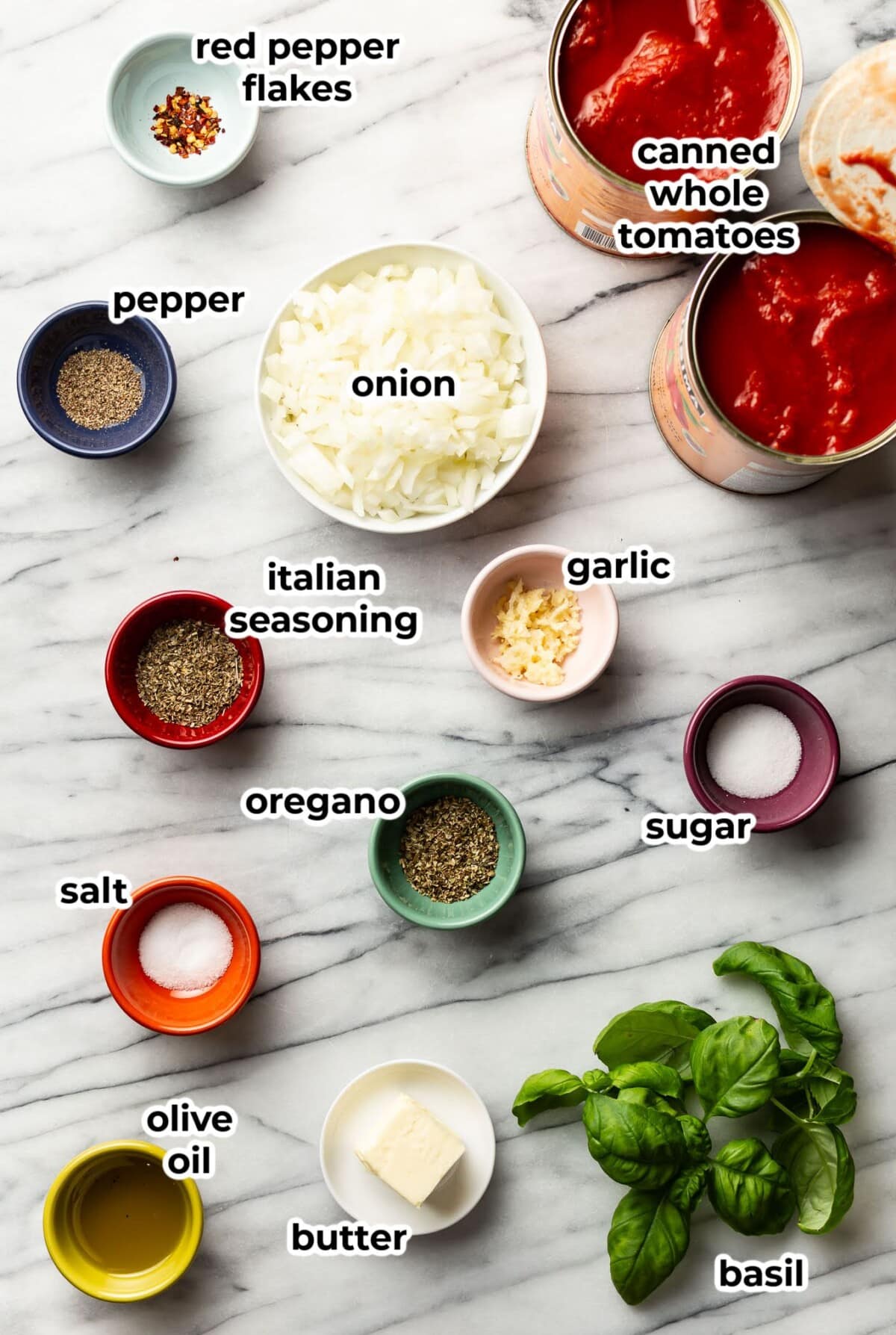 ingredients for tomato sauce in prep bowls