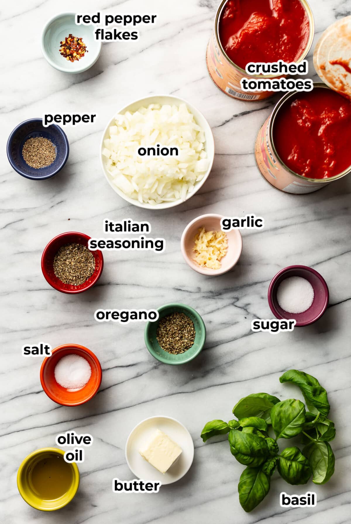 ingredients for tomato sauce in prep bowls