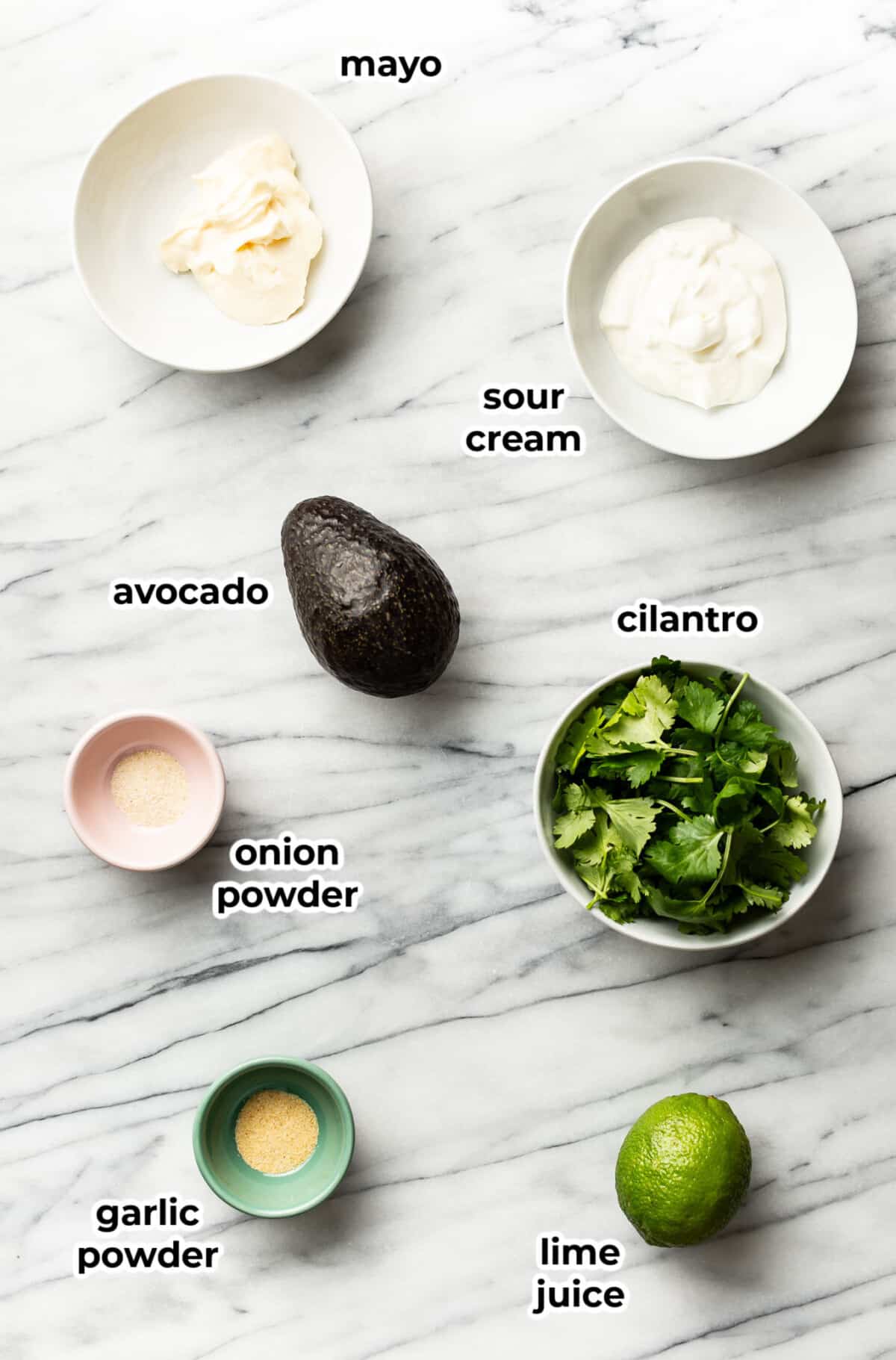 ingredients for avocado sauce in prep bowls