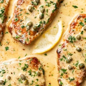 a skillet with pork chops piccata