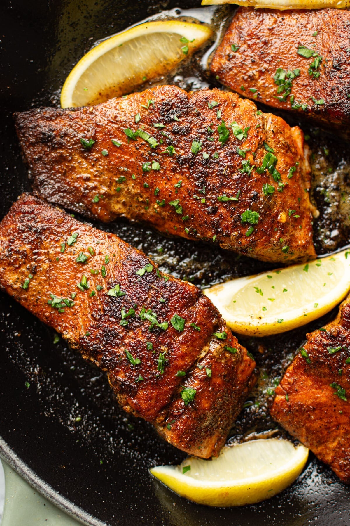 a skillet with blackened salmon