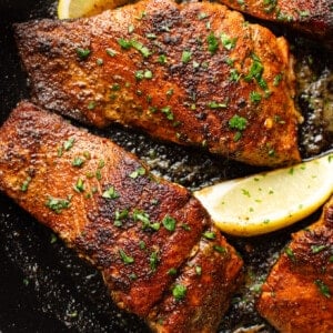 a skillet with blackened salmon