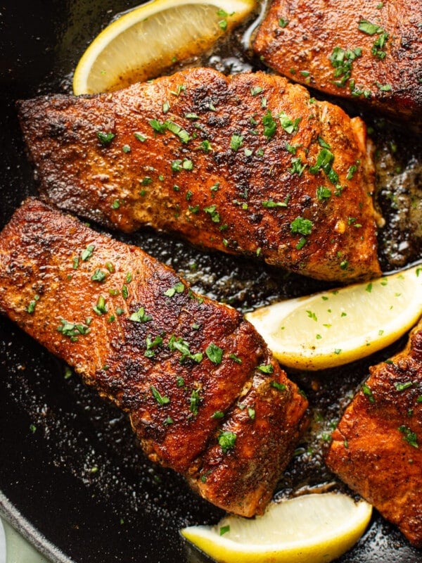 a skillet with blackened salmon