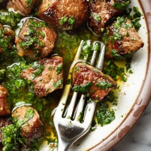 a plate with steak bites coated in gremolata