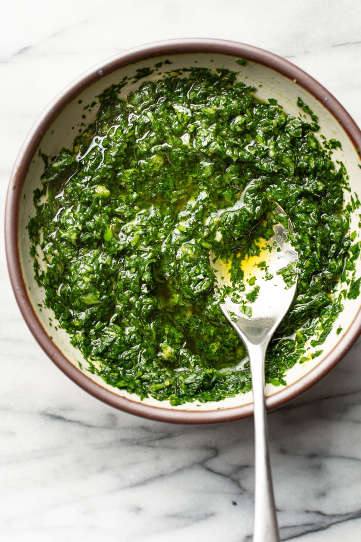 a bowl with homemade gremolata and a spoon