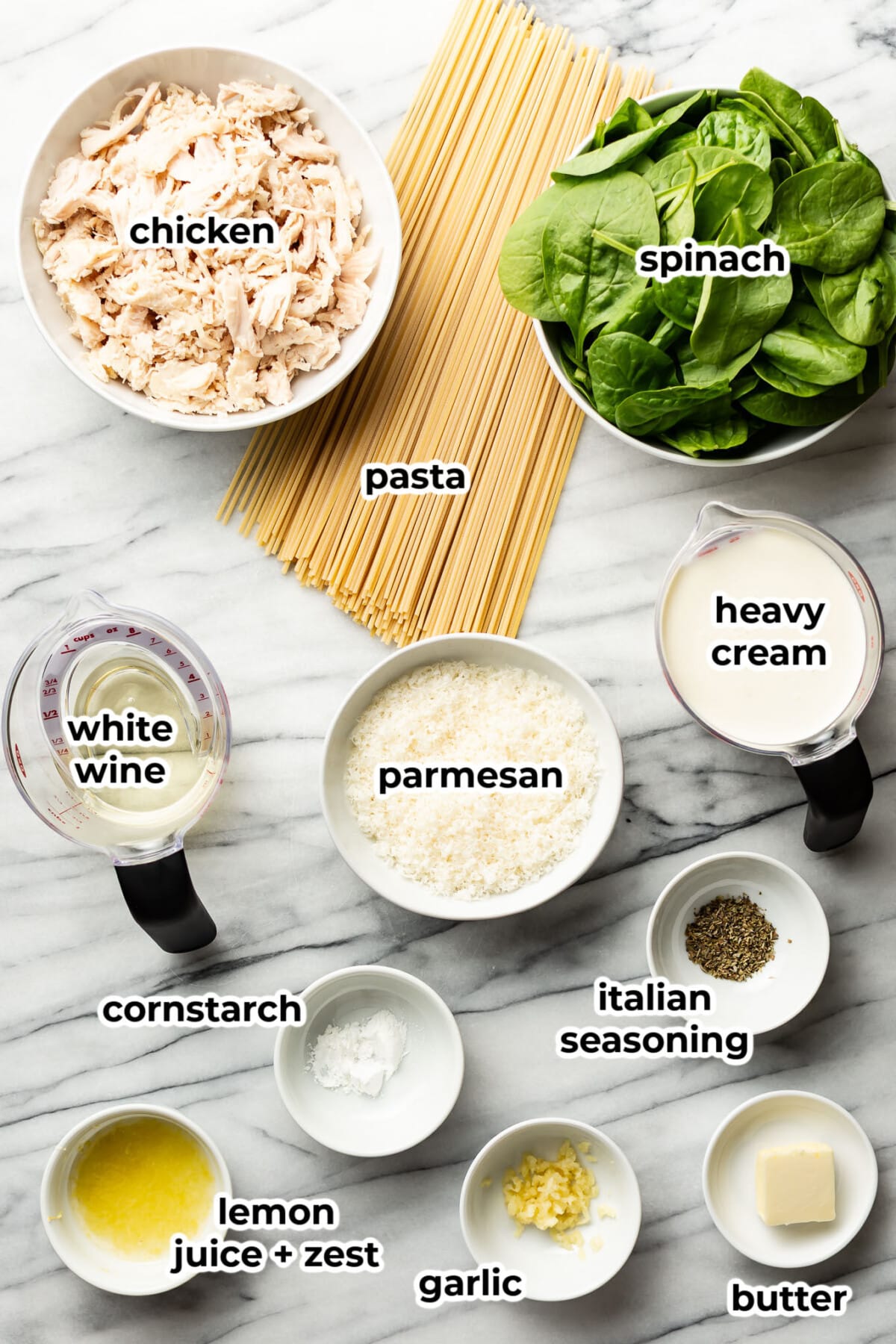 ingredients for lemon spinach chicken pasta in prep bowls