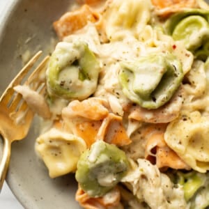 a bowl with pesto chicken tortellini