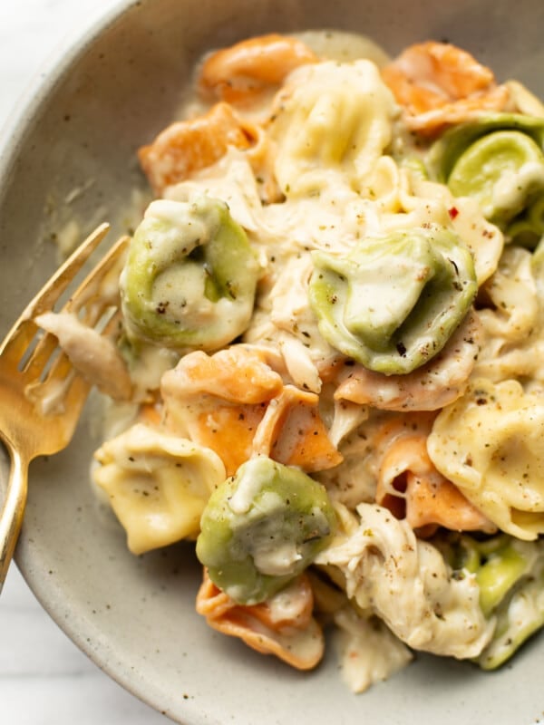 a bowl with pesto chicken tortellini