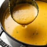 a pot of spicy lentil soup with a ladle