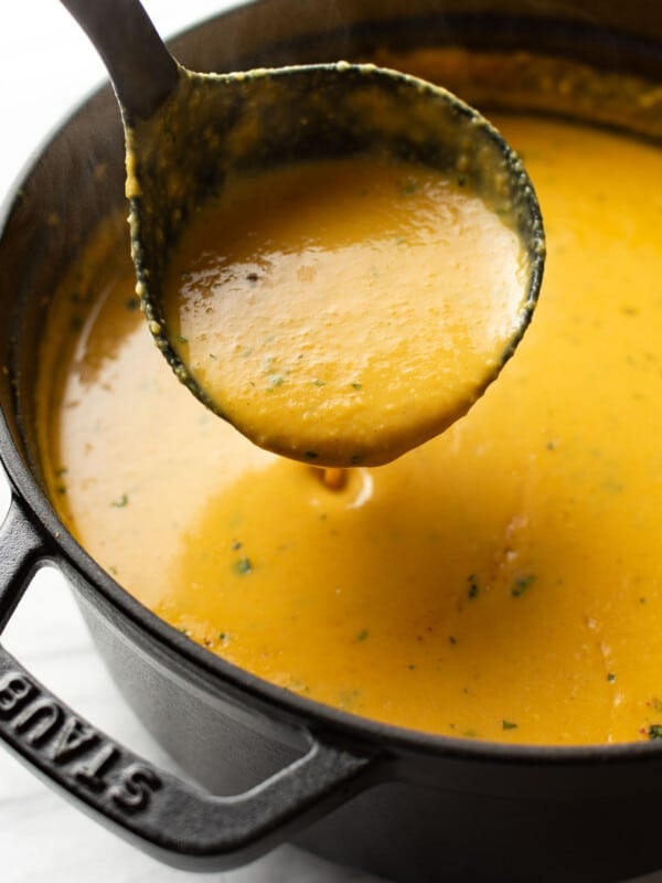 a pot of spicy lentil soup with a ladle