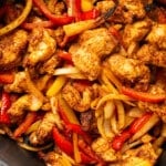 an air fryer basket with chicken fajitas