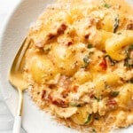 a bowl of marry me chicken gnocchi with a fork