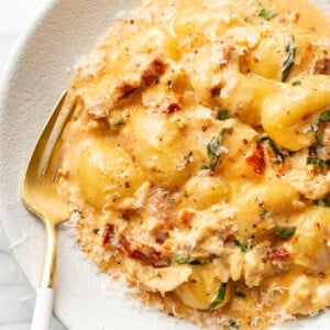 a bowl of marry me chicken gnocchi with a fork