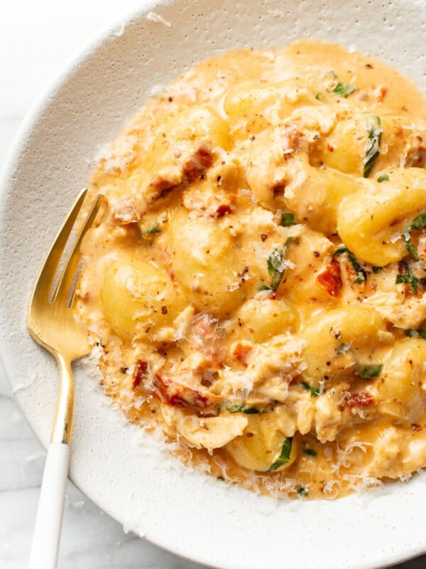 a bowl of marry me chicken gnocchi with a fork