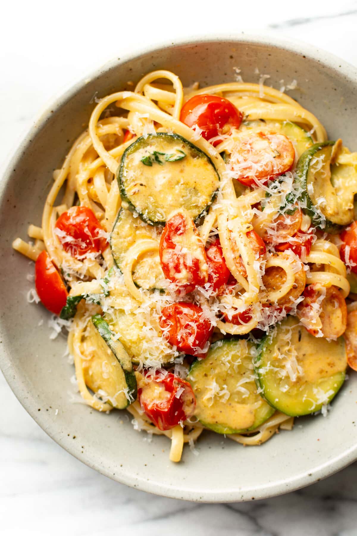 a bowl of zucchini tomato pasta