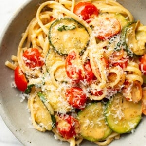 a bowl of zucchini tomato pasta