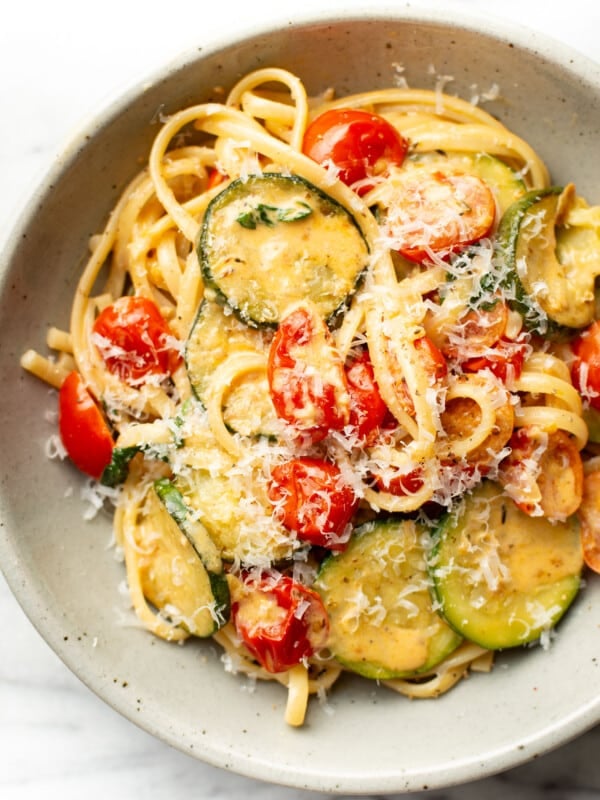 a bowl of zucchini tomato pasta