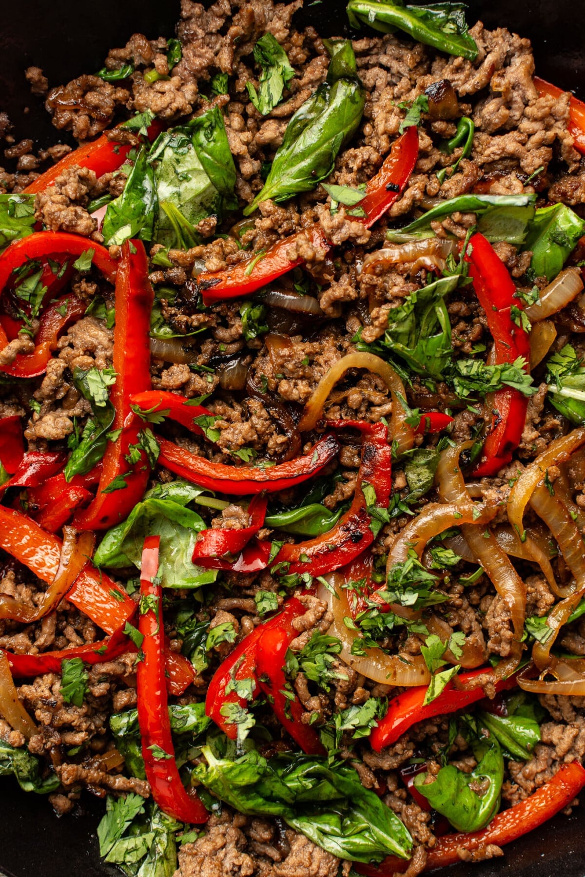 a skillet with thai basil beef