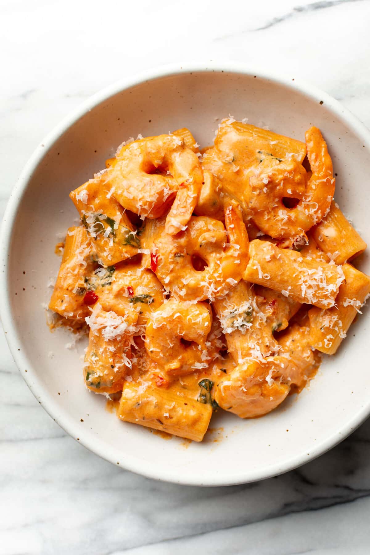 a bowl of spicy shrimp pasta with rigatoni